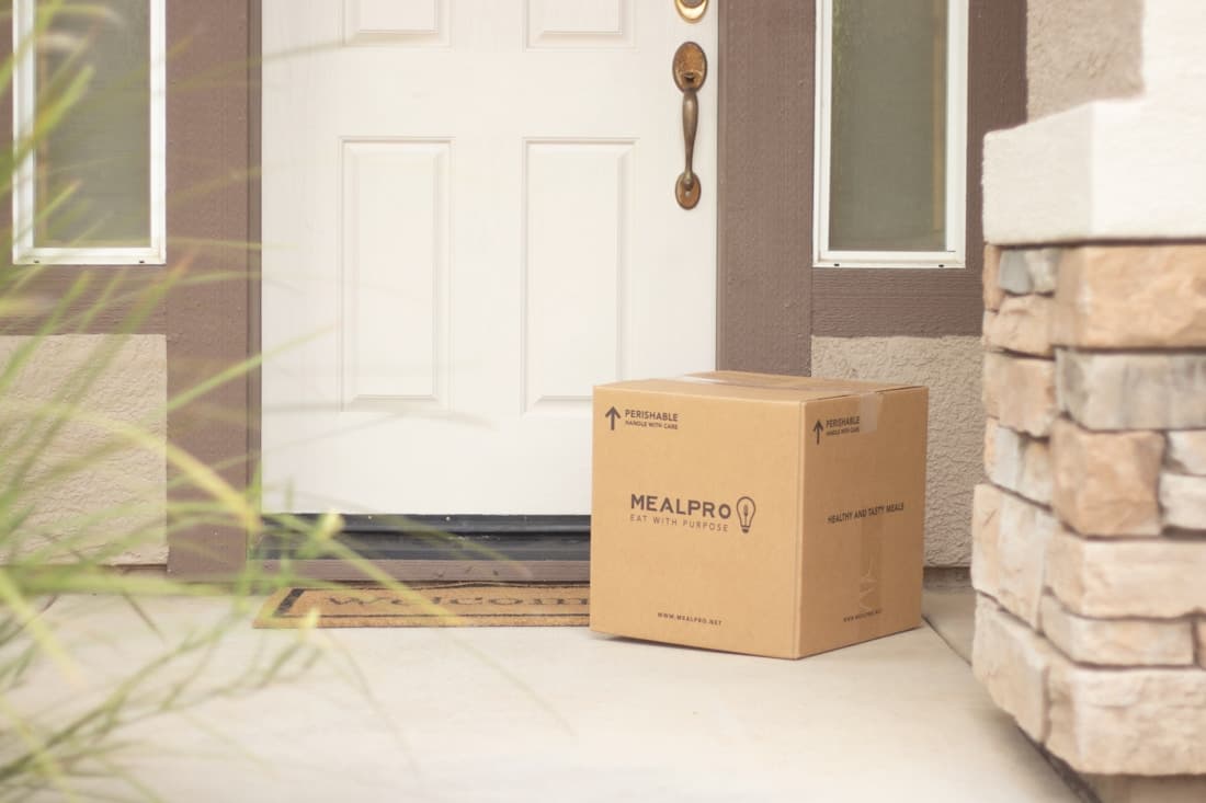 A cardboard parcel left beside a front door