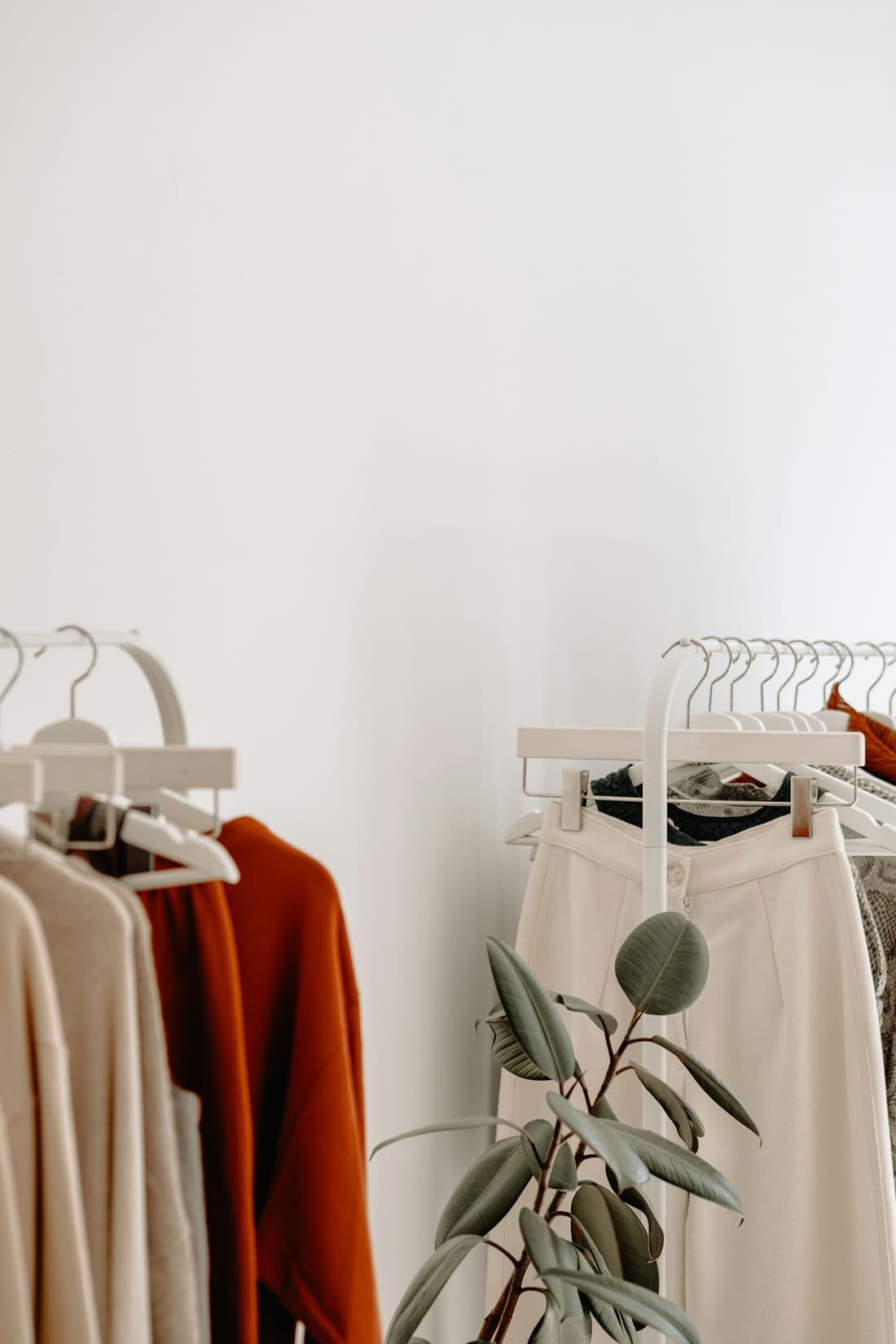A rail of clothes in neutral tones
